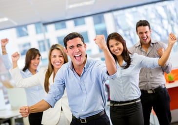 Business team celebrating a triumph with arms up